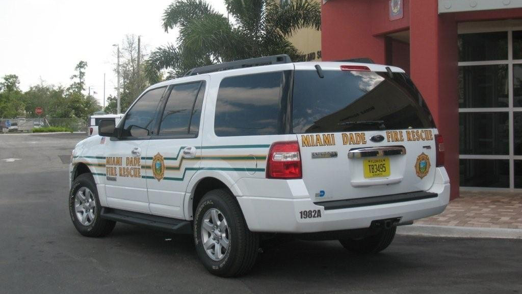 miami dade white fire rescue car with yellow and green font design