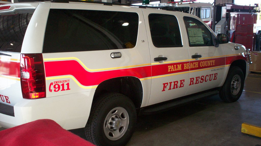 palm beach fire and rescue car with red and yellow font design