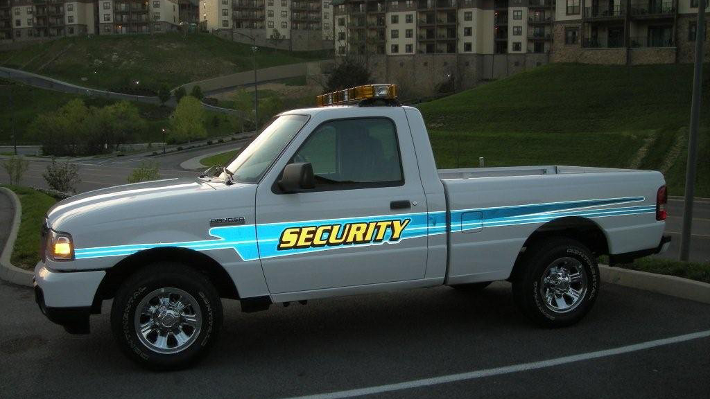 gdi designed security pickup parked in the field