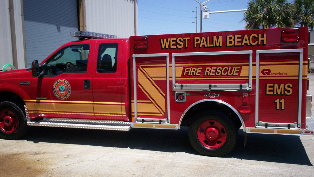 sideview of west palm beach fire rescue truck with gold font design