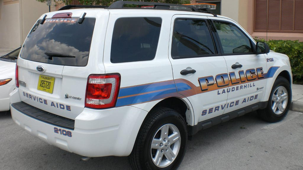 lauderhill white police service aide car with orange and blue font color design