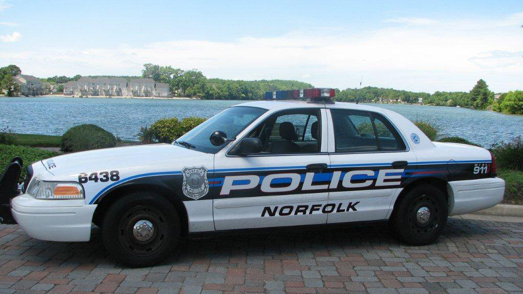 white and blue graphic design of norfolk police car
