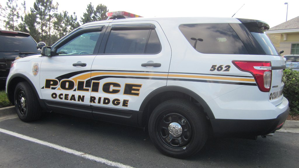 white ocean ridge police with yellow and black line design
