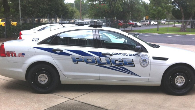 ormond beach police white car with blue font and logo design parked