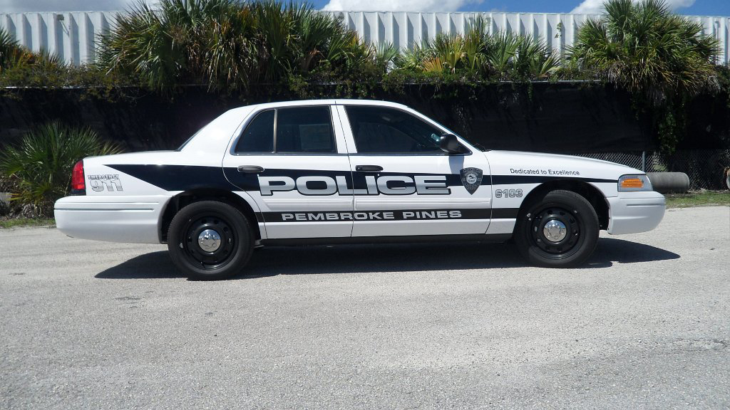white pembroke pines police car with blue and white font design