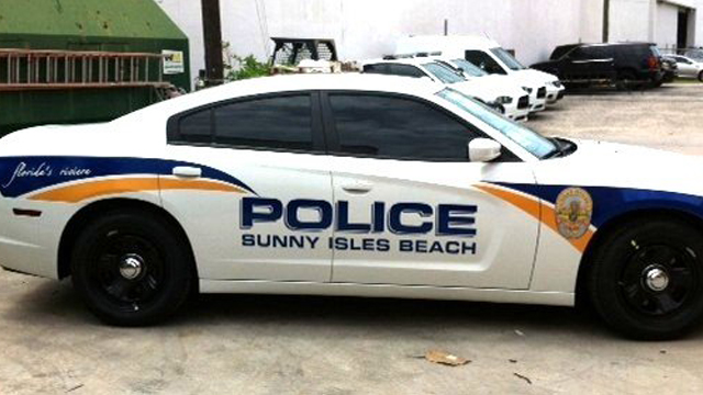 white police car with yellow and blue line design